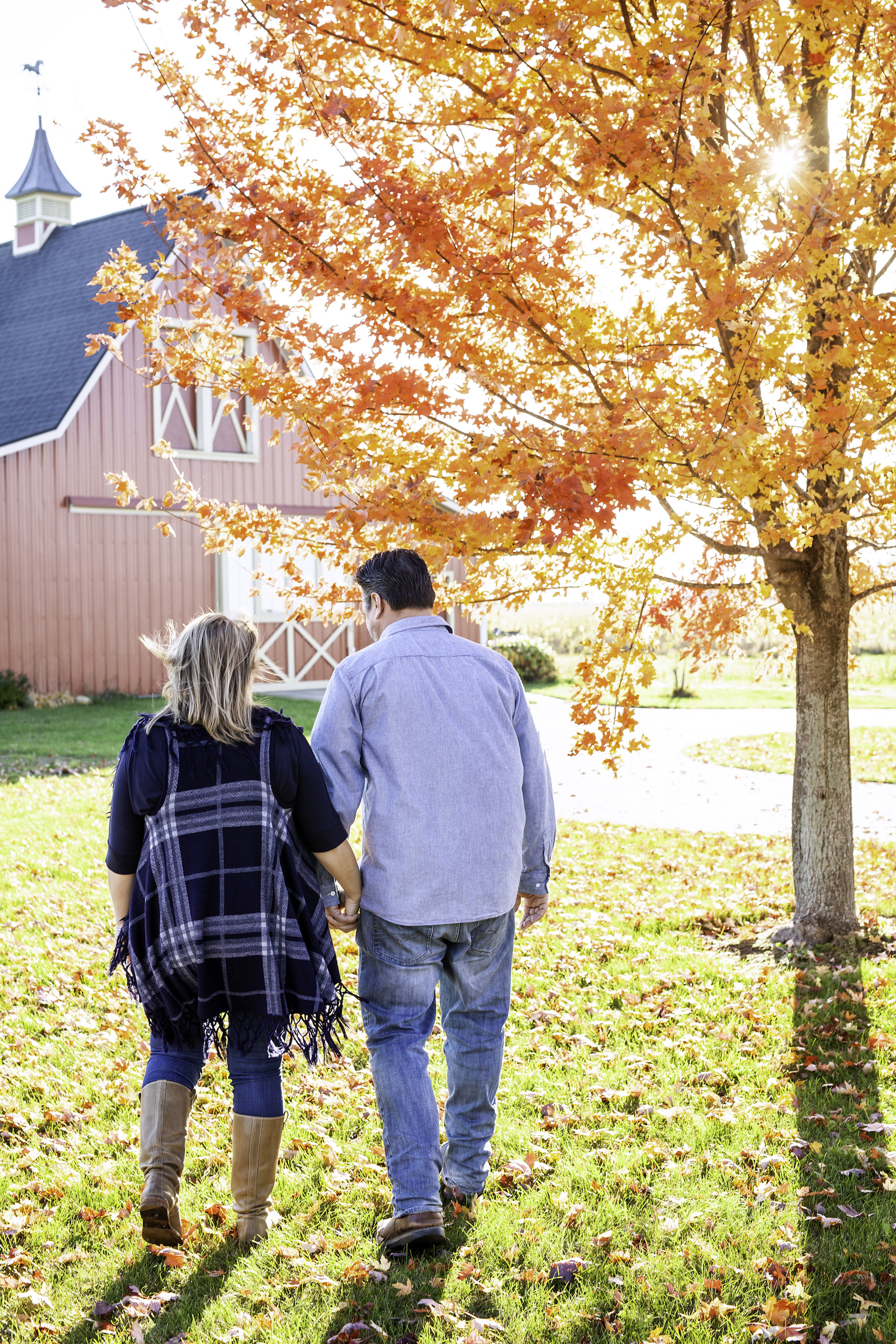 Couple holding hands walking away