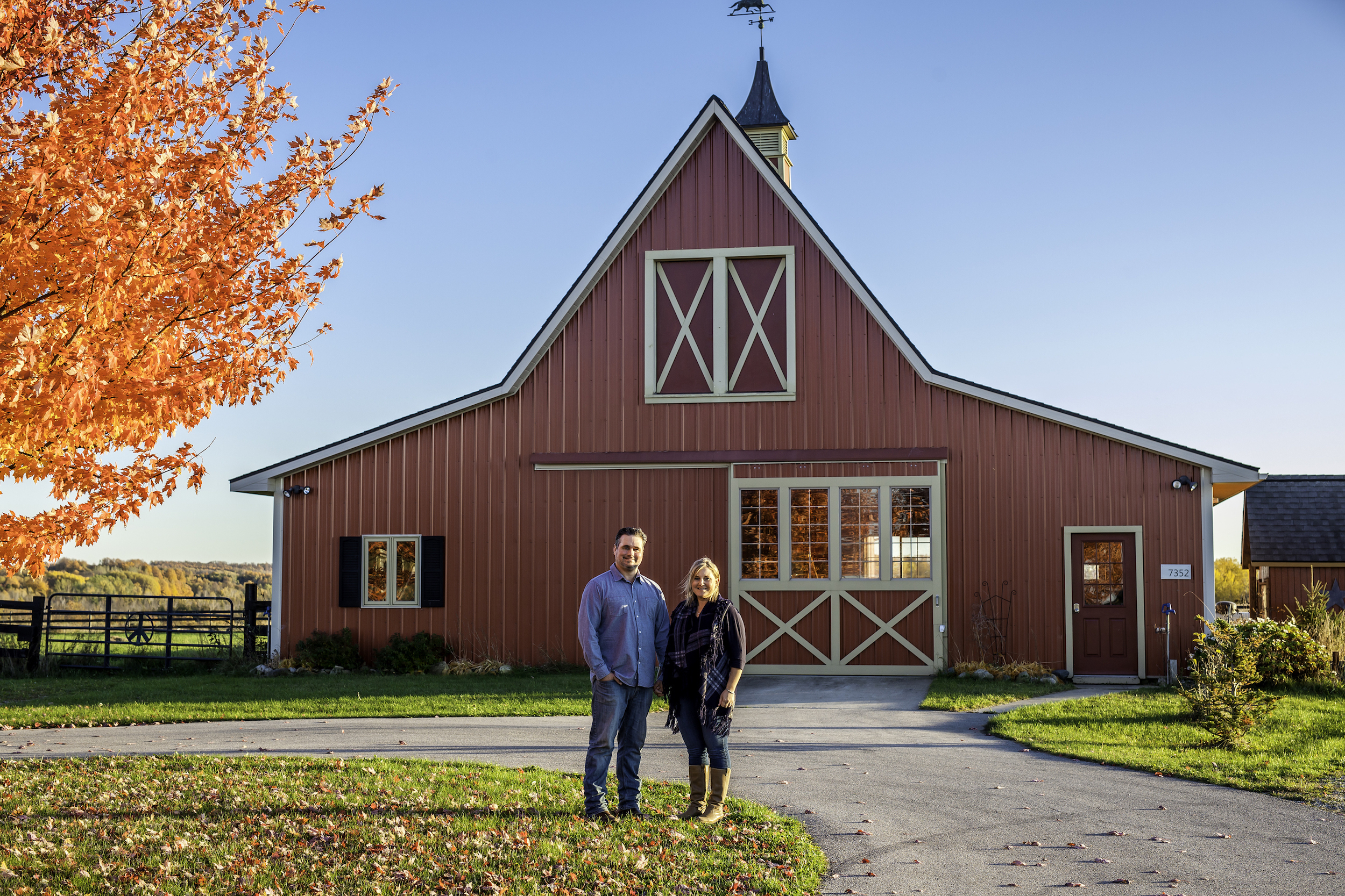 Couple in front of farmhouse