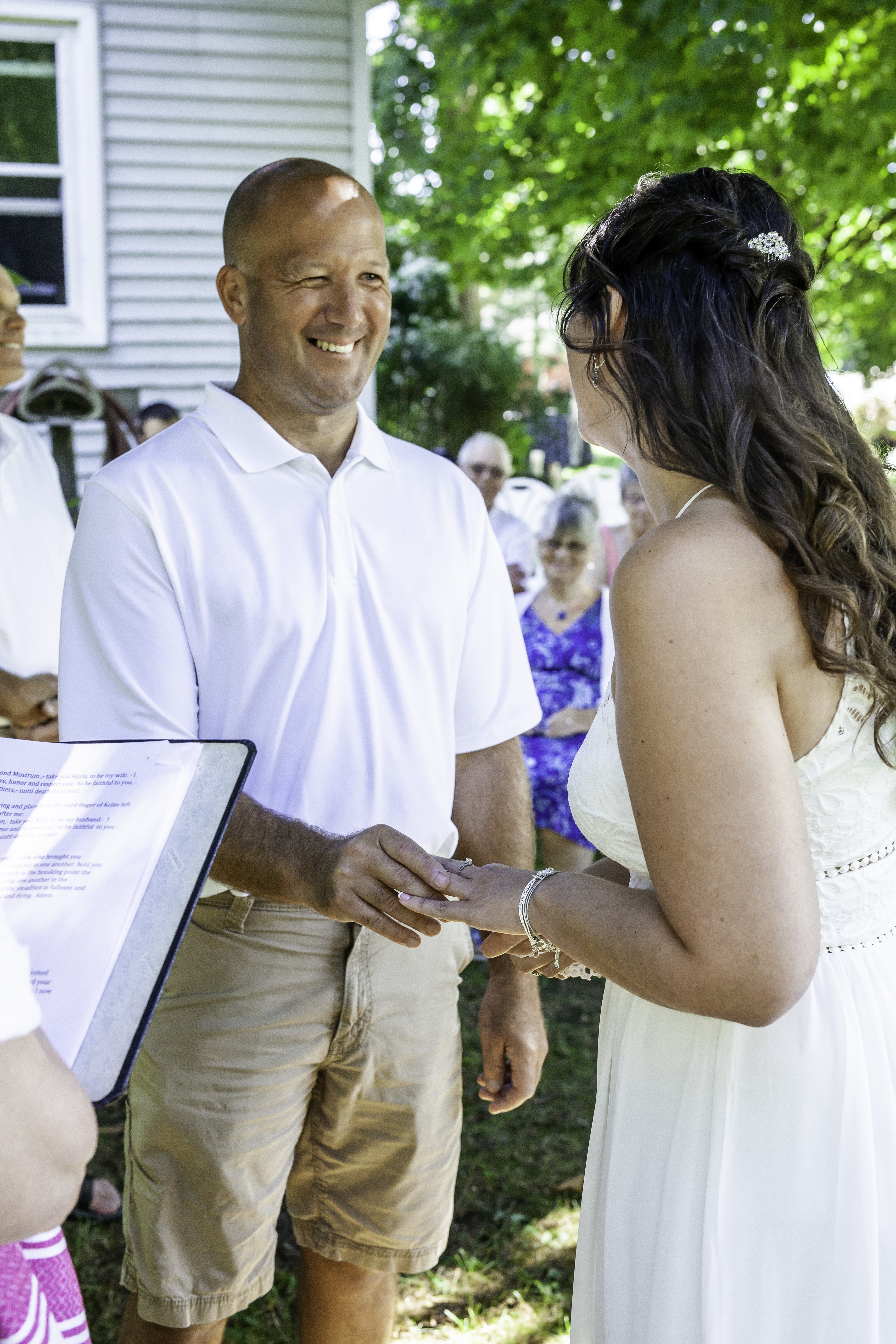 Groom smiling at bride during ceremony