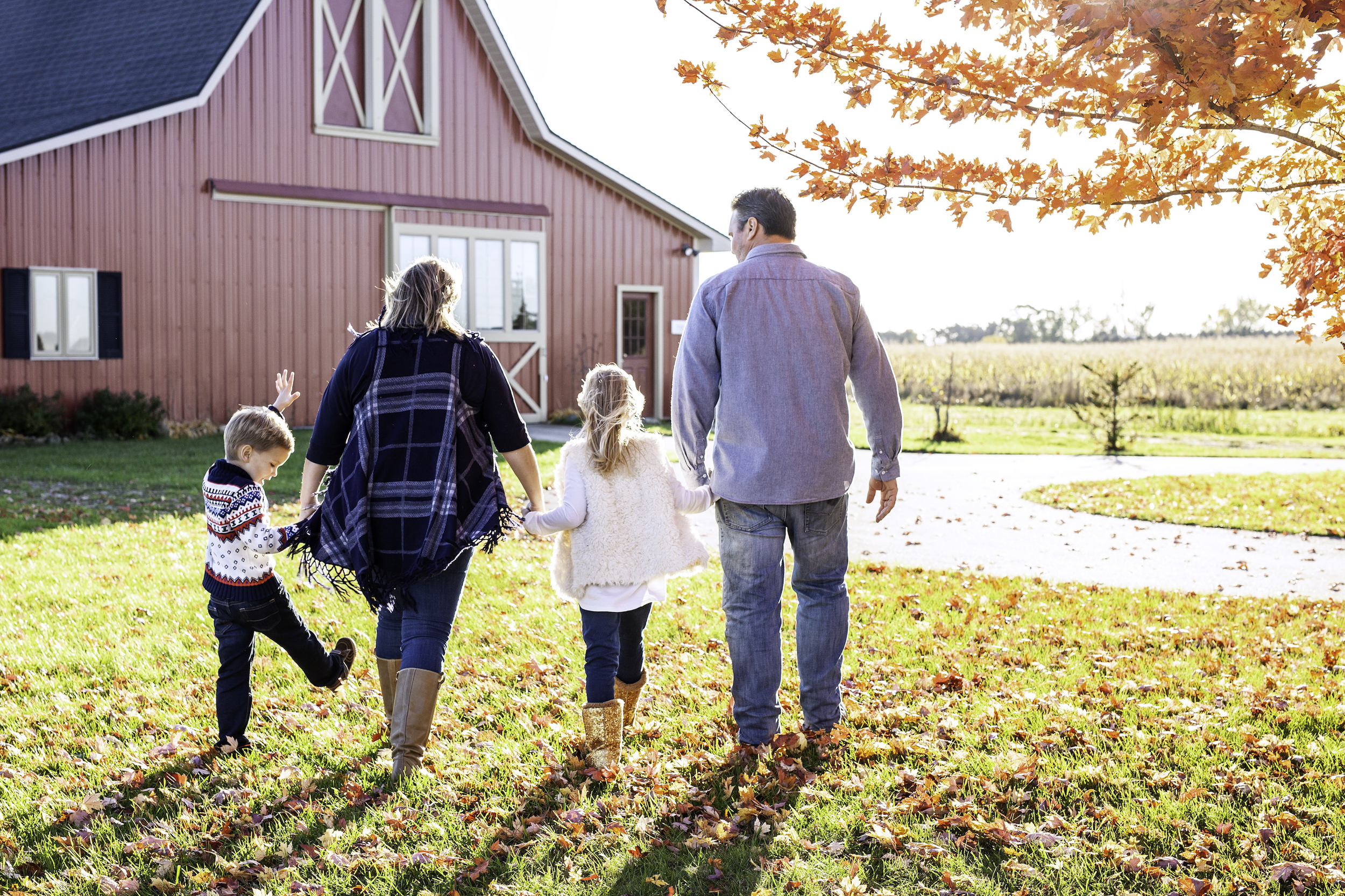 Family holding hands walking away