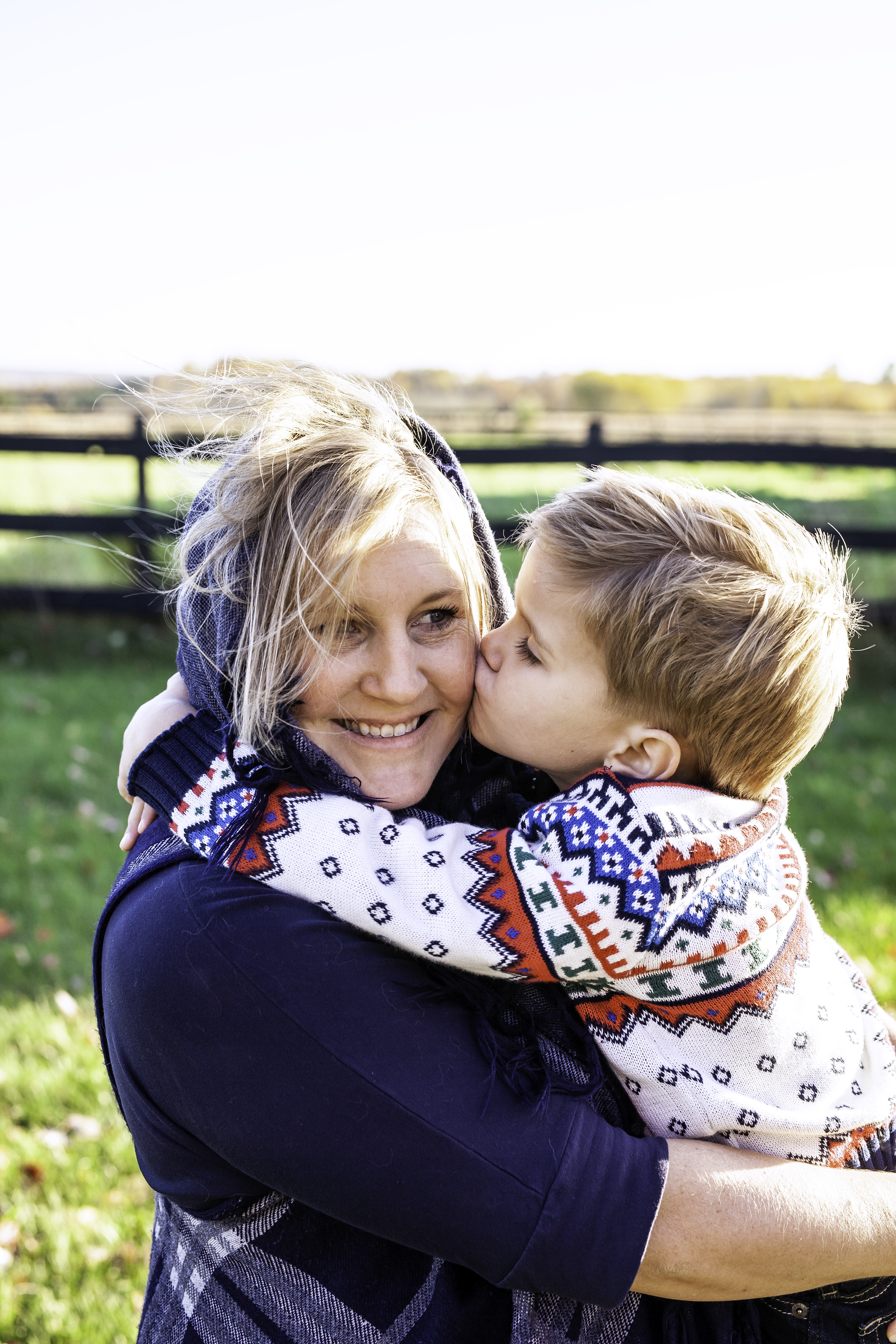 Little boy kissing his mom's cheek