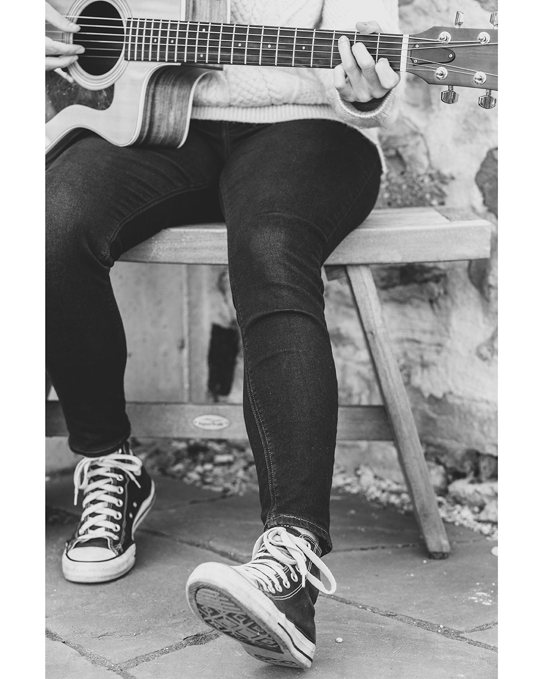 Black and white image of a person playing the guitar