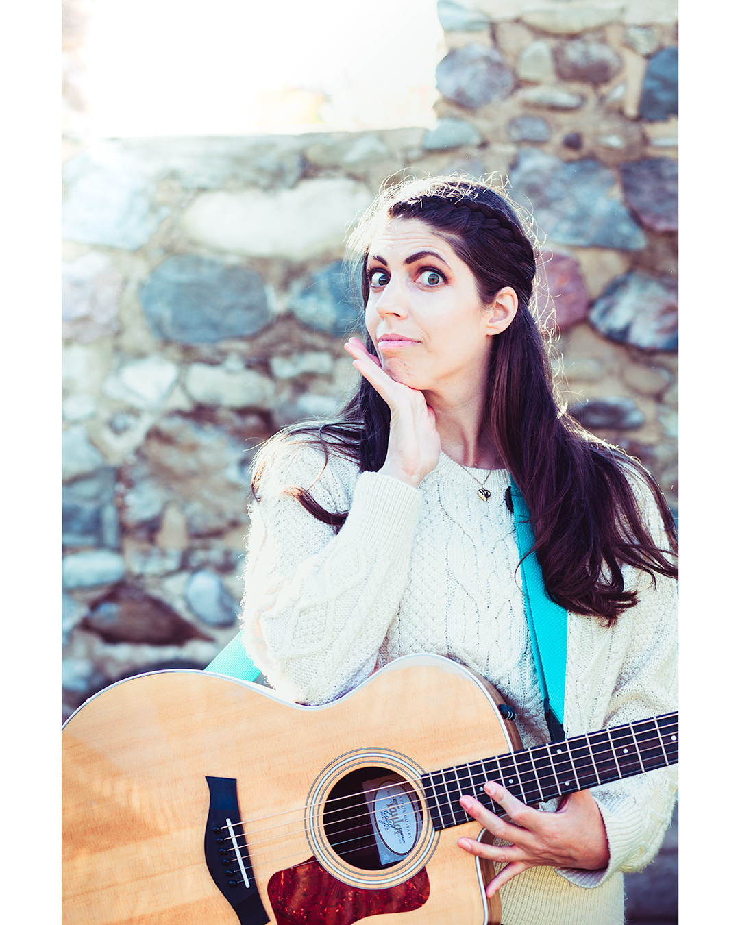 Music Teacher making a funny face while holding a guitar