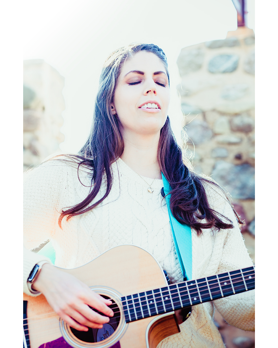 Music Teacher playing the guitar with a look of bliss