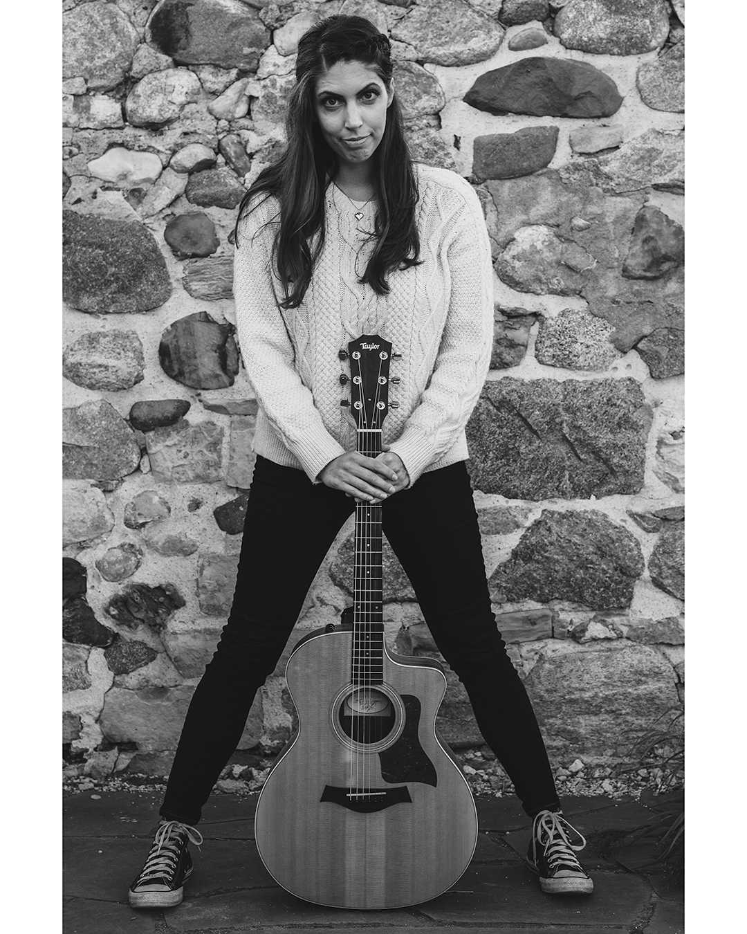Black and white image of a Music Teacher with her guitar