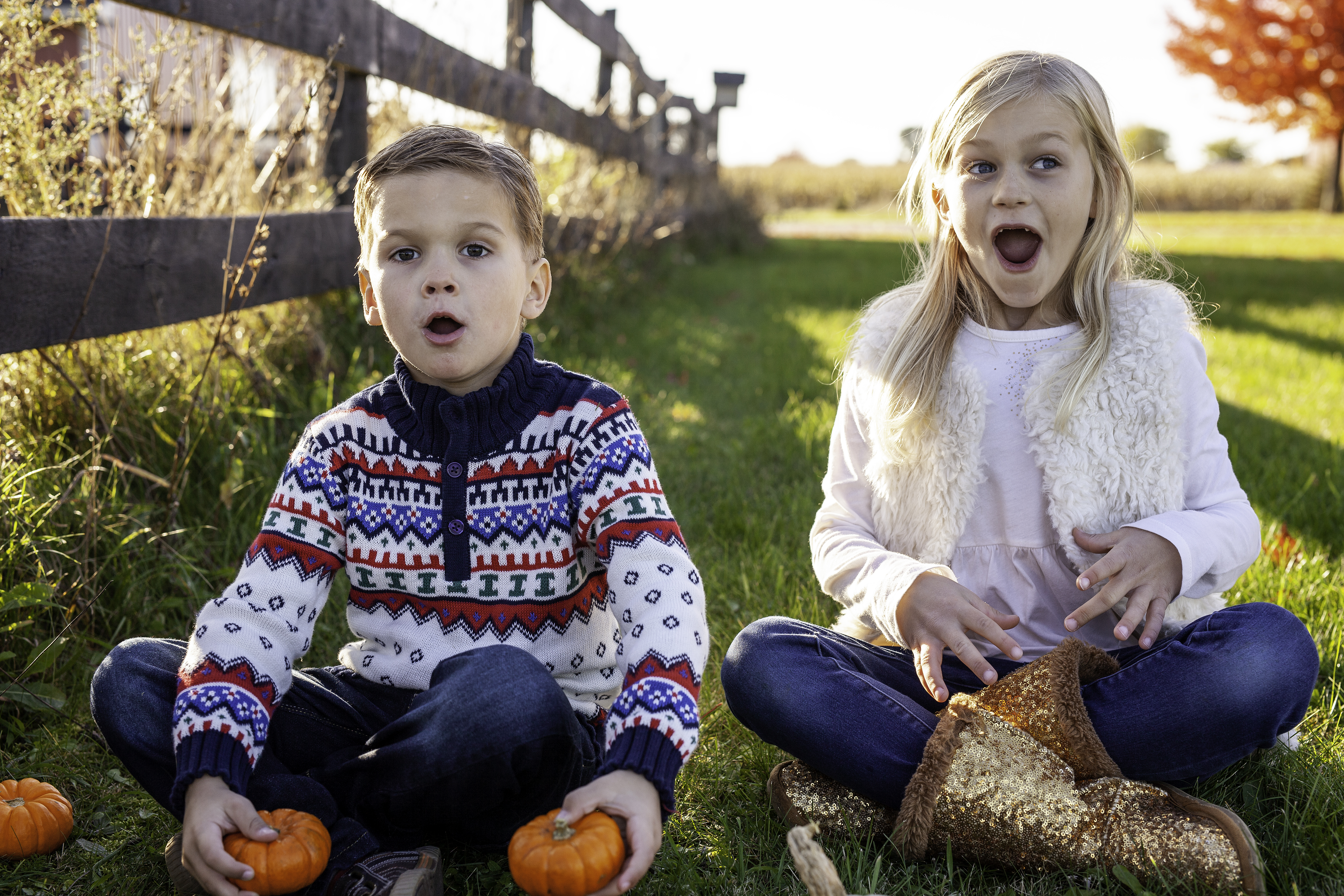 Kids making faces with pumpkins