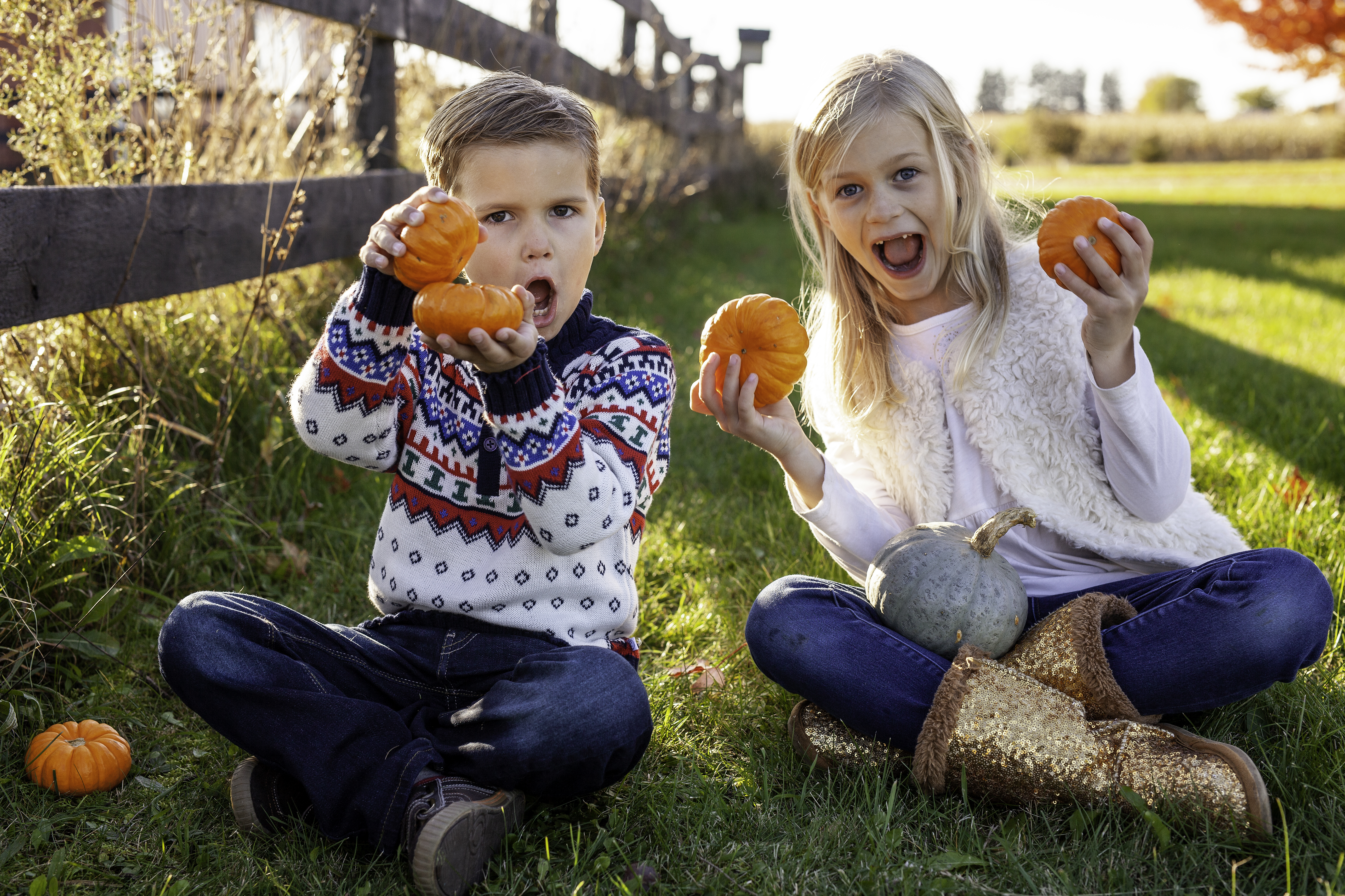 Kids holding pumpkins and making silly faces