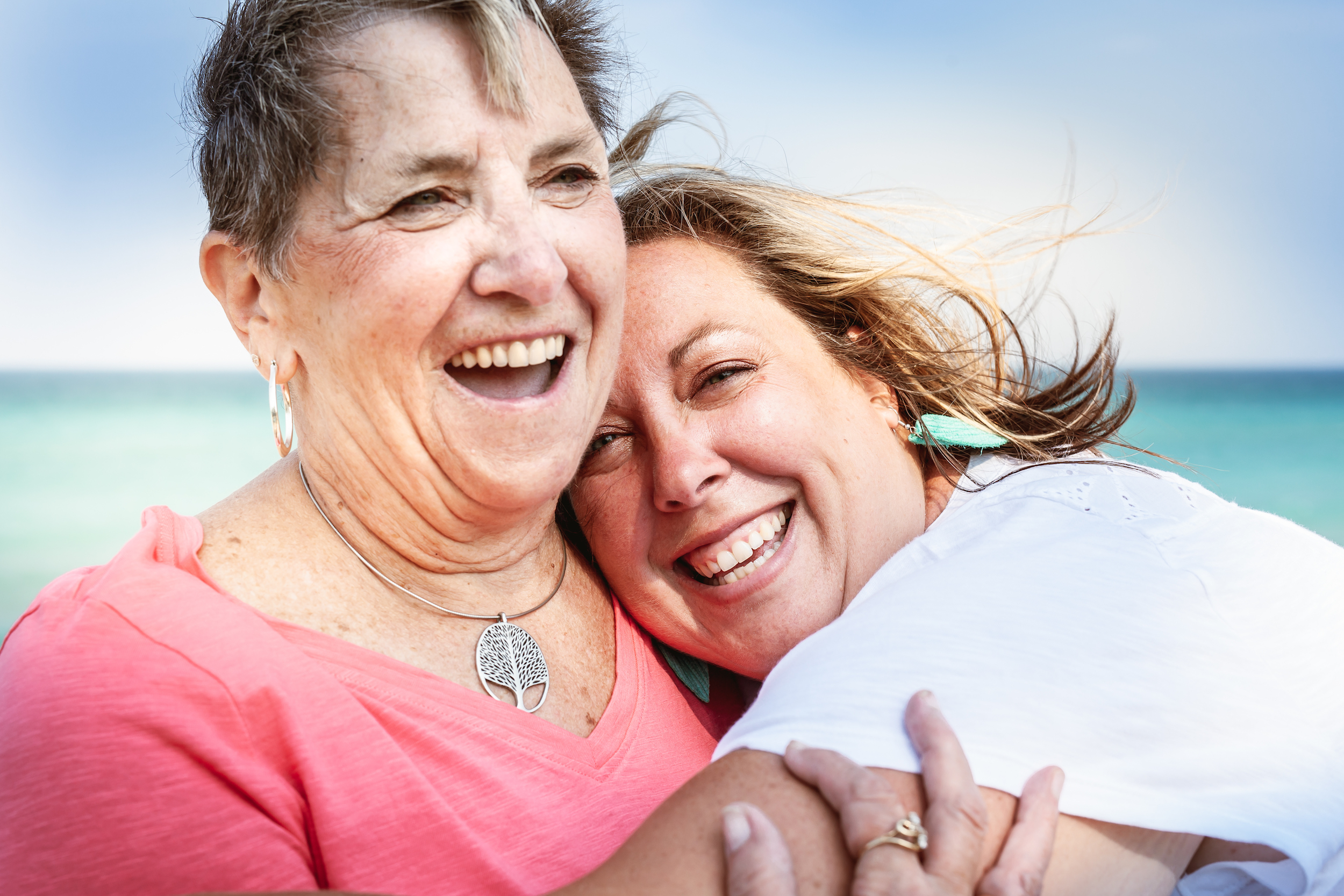 Two woman embracing and smiling
