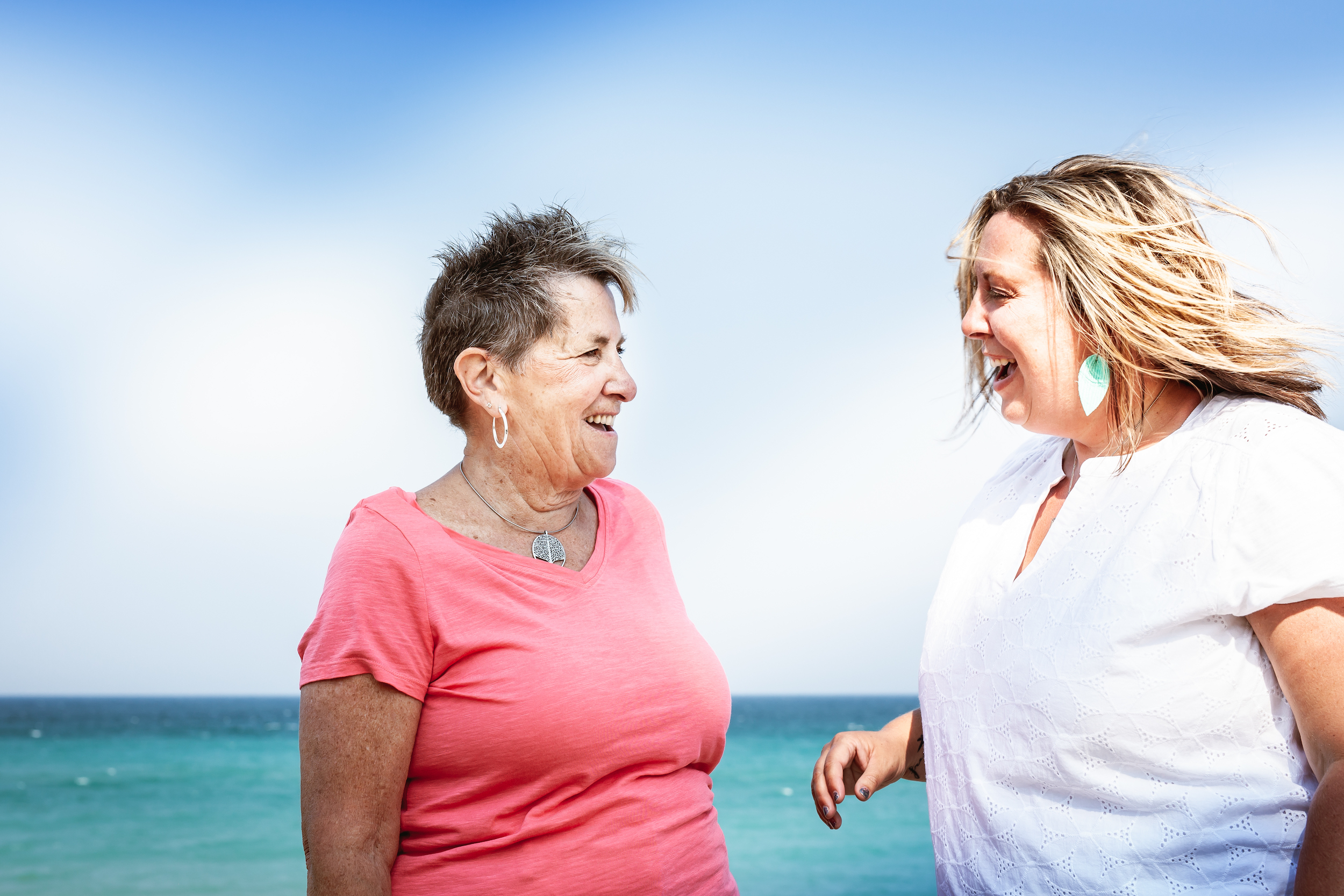 Women laughing near the water