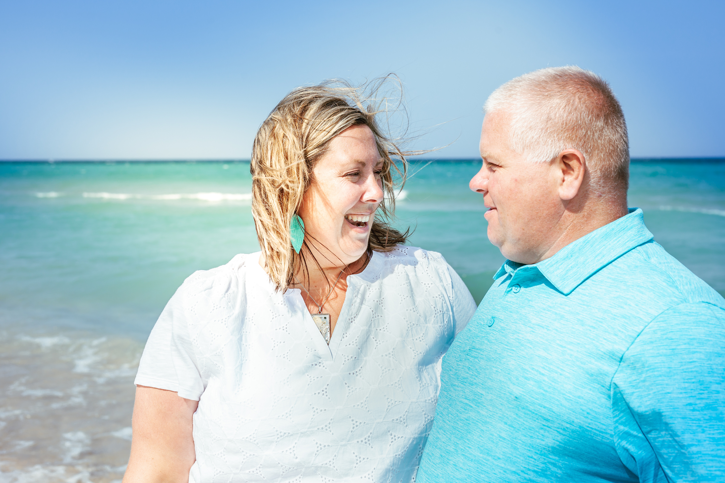 Couple smiling at each other at the beach