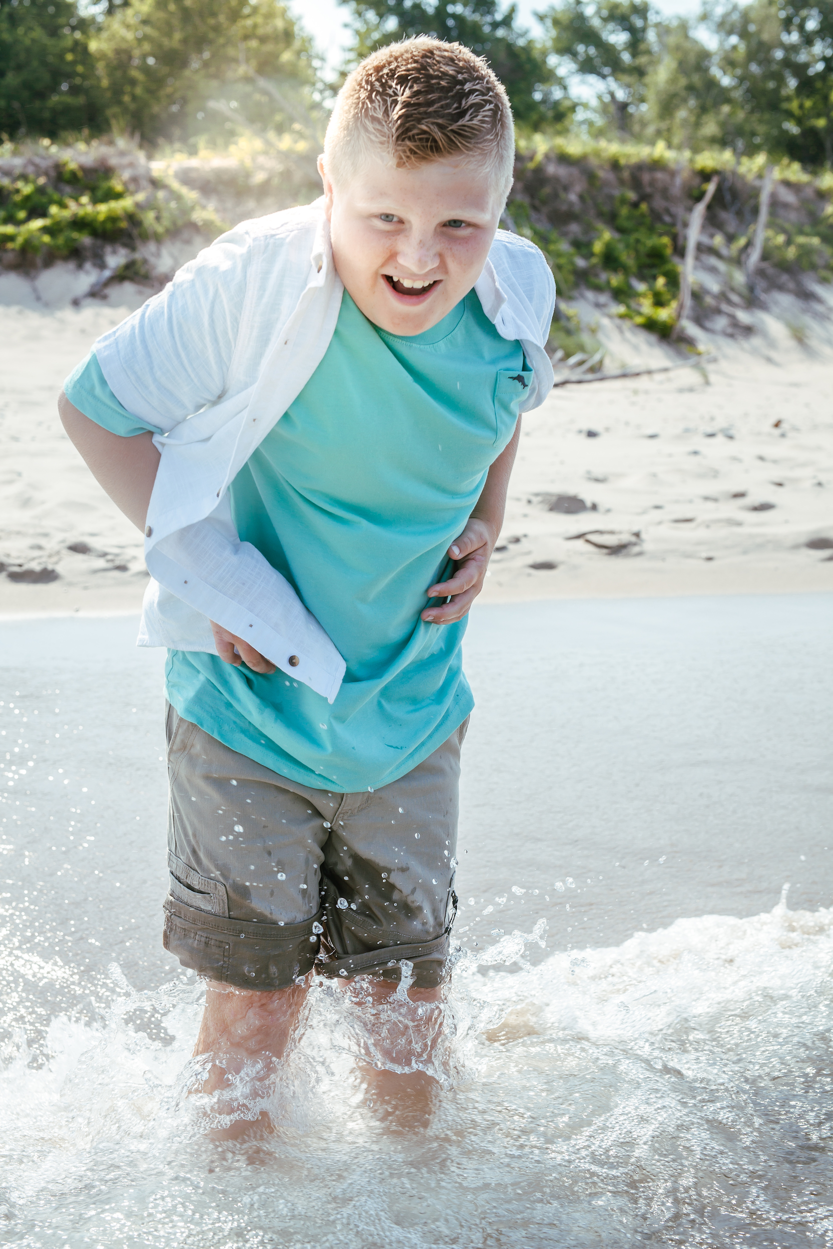 Child splashing in the water at the beach