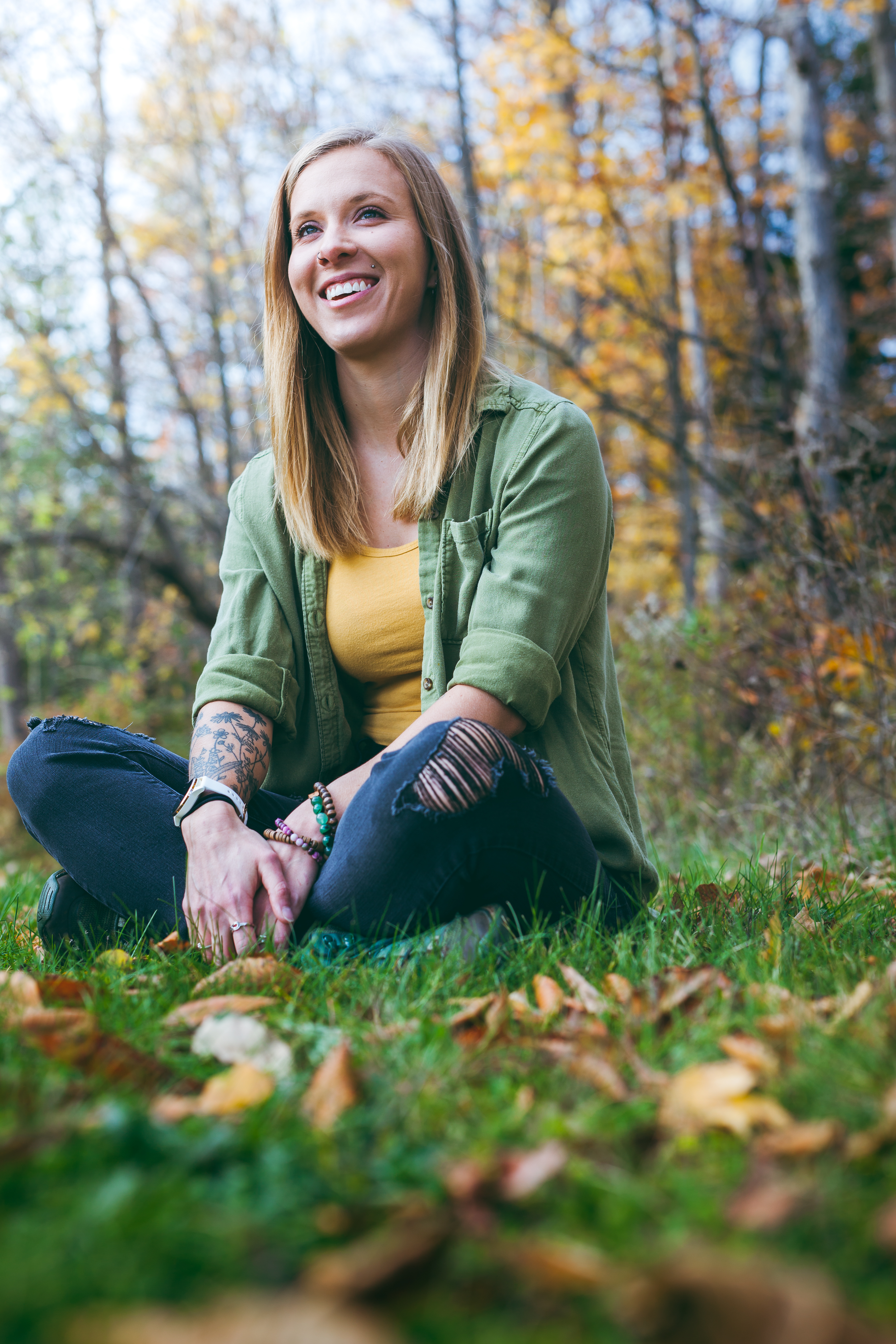 Woman sitting in grass, smiling