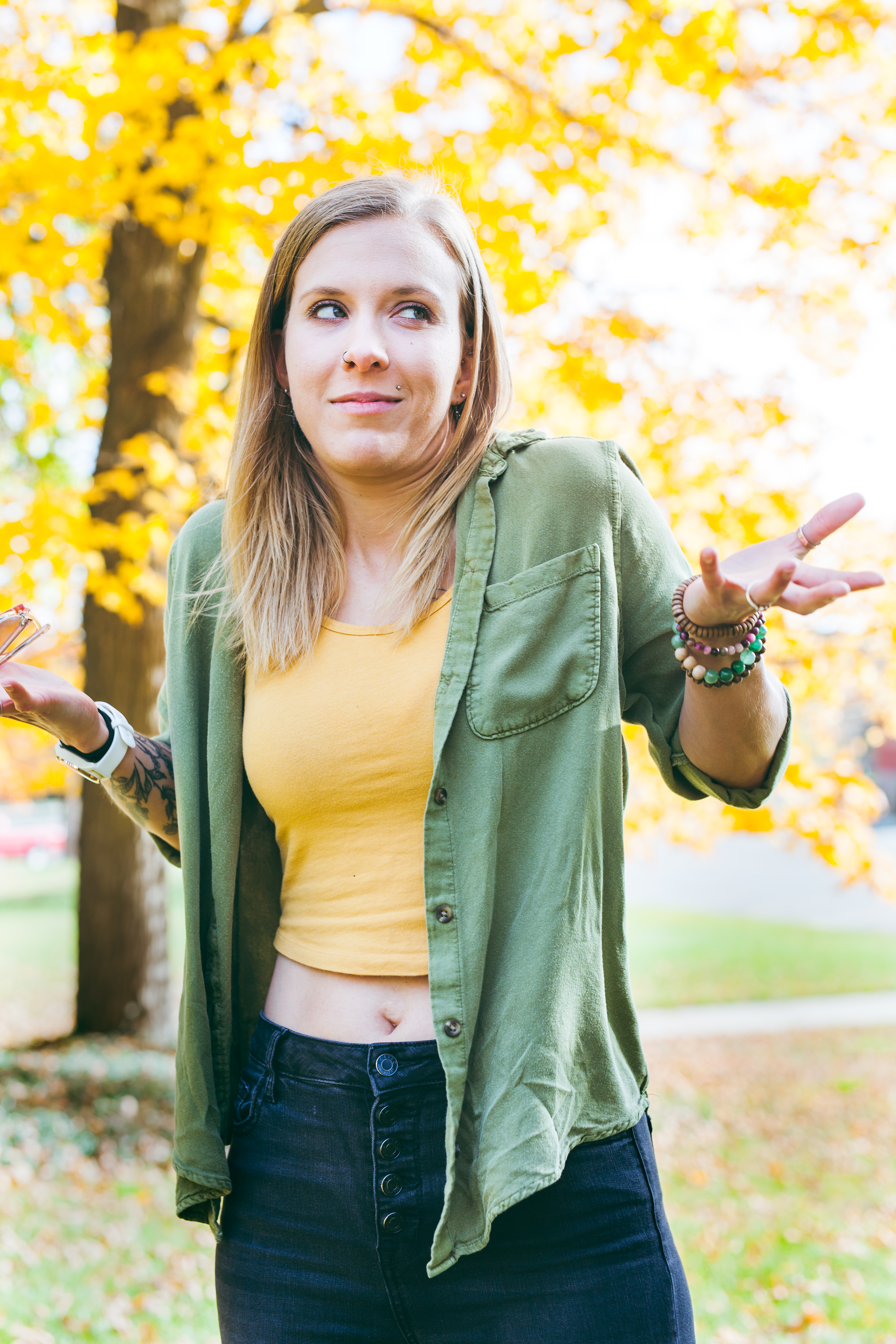 Woman shrugging with a "whatever" pose and face