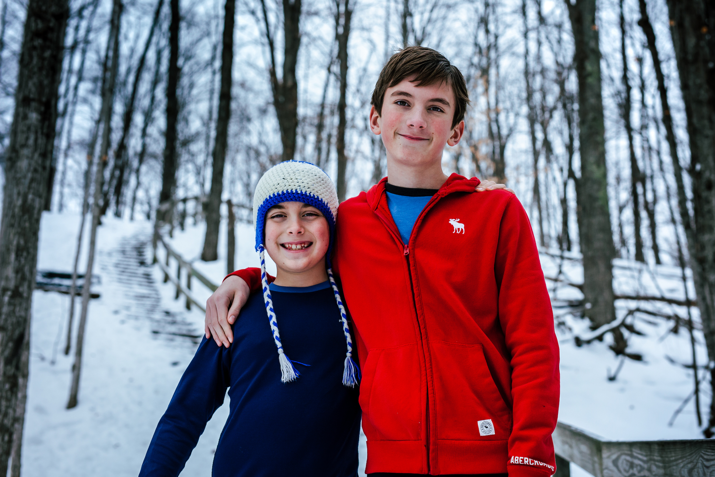 Children smiling in the woods