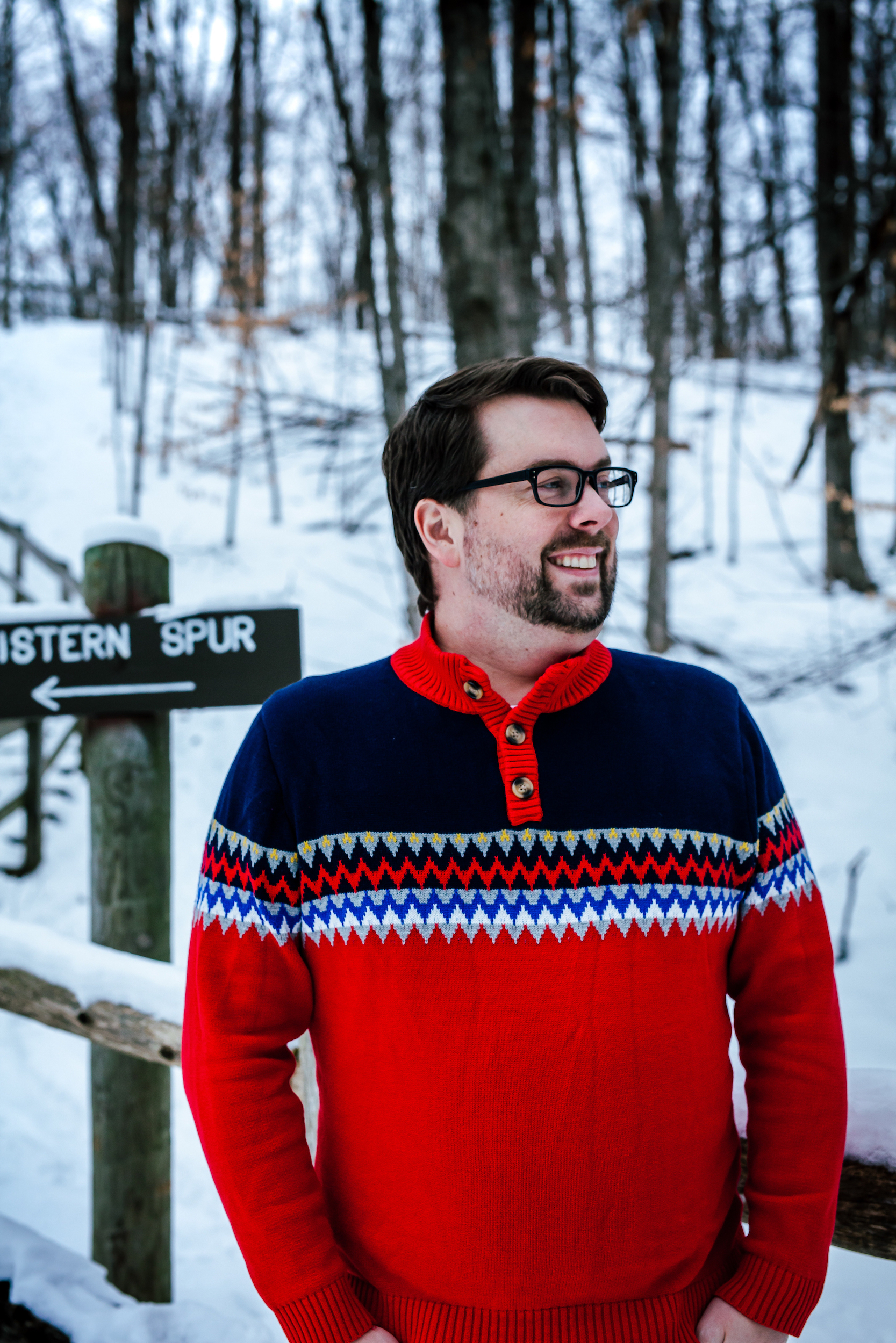 Man smiling on a wooded path