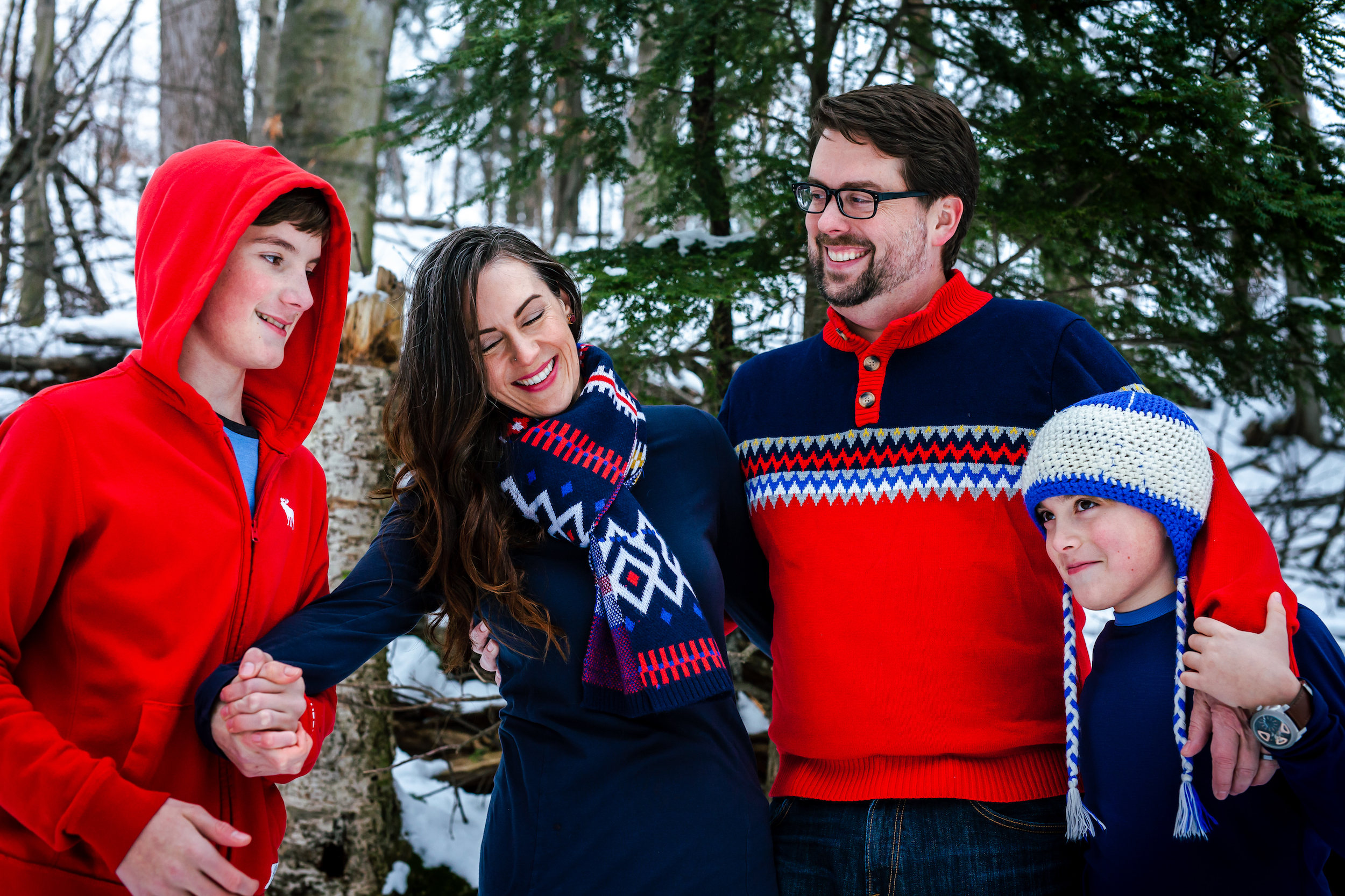 Family smiling in the woods