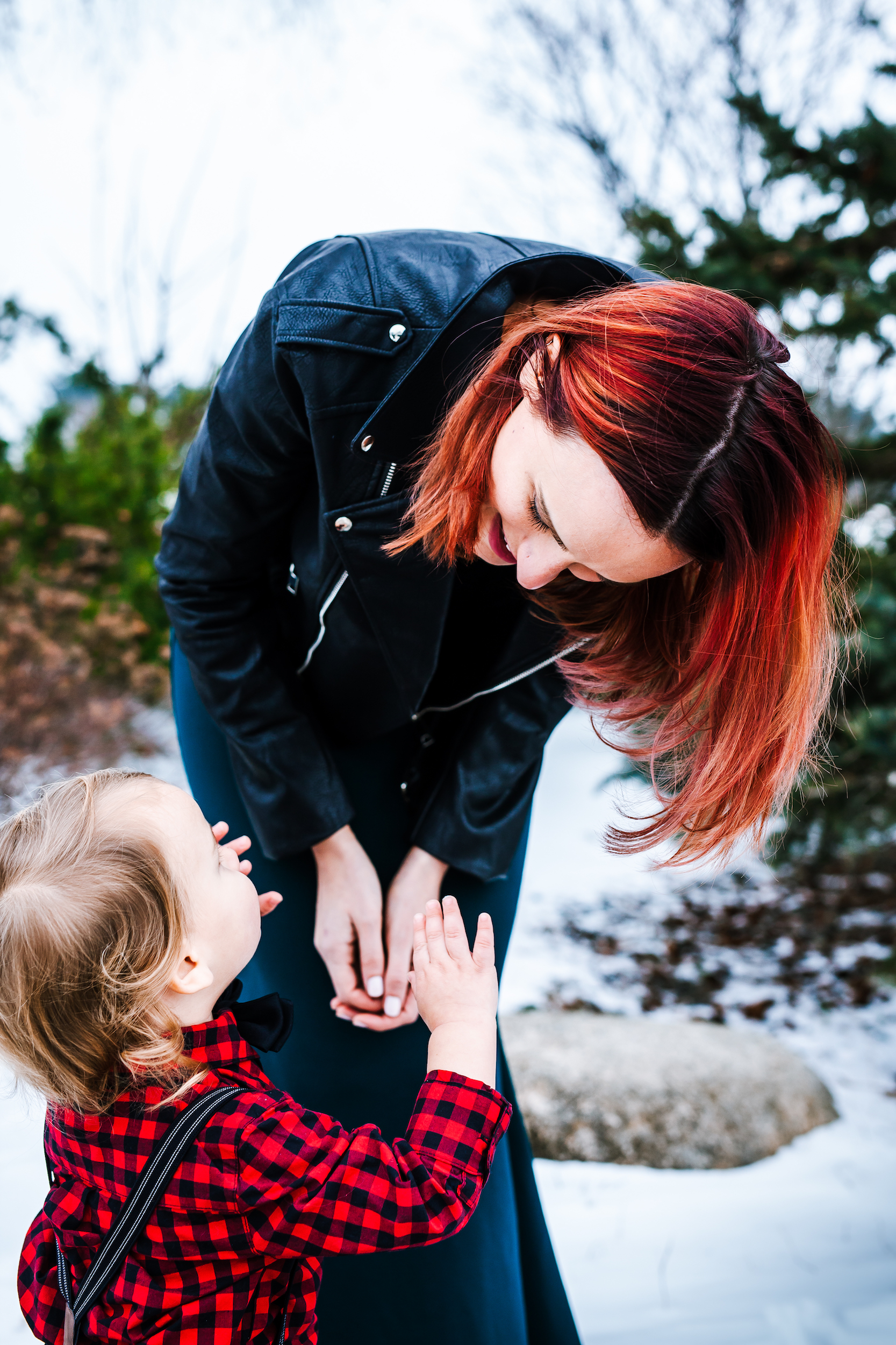 Woman leaning down towards child